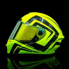 a yellow helmet with black and white designs on it's face is shown against a black background