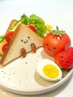 a white plate topped with bread and vegetables next to an egg, tomato and cheese