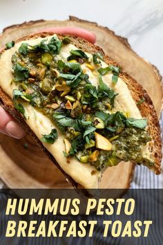 someone is holding up a piece of bread with pesto on it and the words hummus pesto breakfast toast