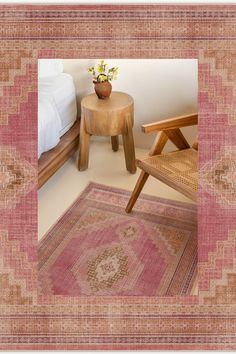 a chair and table in a room with a rug on the floor next to it