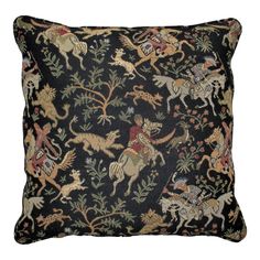 a black pillow with horses and flowers on it