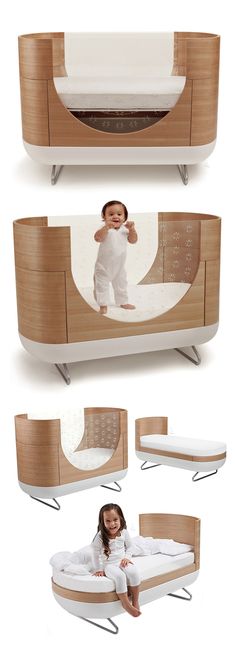 the baby bed is made from wood and has an infant in it's arms