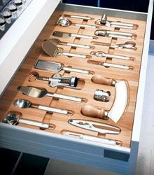 a kitchen drawer with utensils and spoons in it on top of a counter