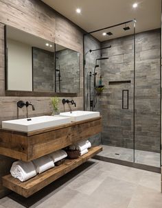 a bathroom with two sinks and a walk in shower