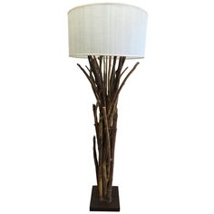 a lamp that is on top of a wooden base with a white lampshade