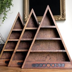 three wooden shelves are stacked on top of each other