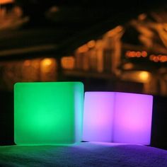 two illuminated cubes sitting next to each other