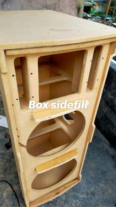 an unfinished wooden speaker box with the bottom section removed from it's side view