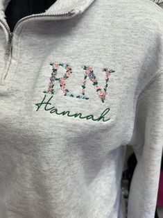 a close up of a person wearing a hoodie with the word kanni embroidered on it