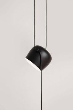 a black lamp hanging from the ceiling with two lights on each side and one light in the middle