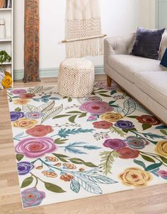 a living room with a couch and rug on the floor