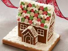 a gingerbread house decorated with candy and sprinkles