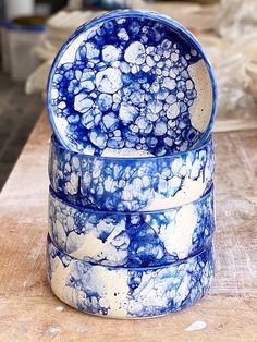 three blue and white bowls stacked on top of each other