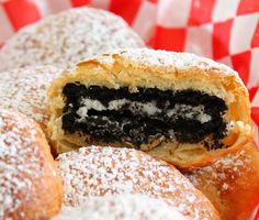 a basket filled with pastries covered in powdered sugar and oreo cookie toppings