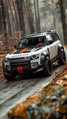 a white and orange car driving down a forest road