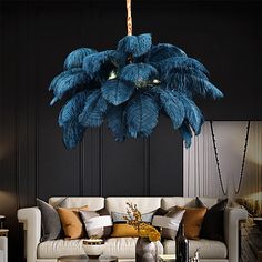 a living room filled with furniture and a palm tree hanging over the top of it