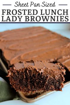 a close up of a piece of chocolate cake with frosting on it and the text overlay says sheet pan sized frosted lunch lady brownies