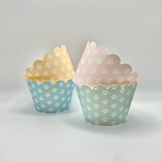 two cupcake cases with paw prints on them