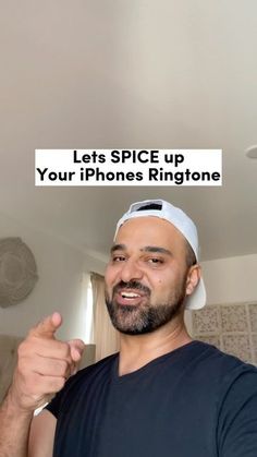 a man pointing to his phone with the caption let's spice up your iphone ringtone