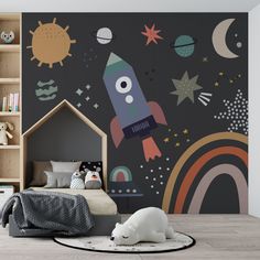 a child's room with a rocket ship mural on the wall and a bed