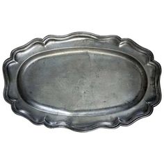 an oval metal tray with scalloped edges