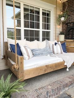 a porch swing bed with pillows on it