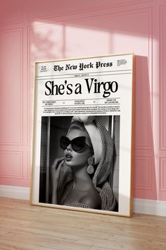 the new york times newspaper advertises she's a virgo in front of a pink wall