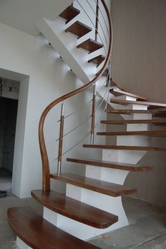 a wooden and white spiral staircase in a house