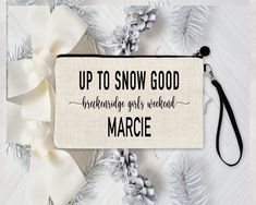 a white and black pouch with the words up to snow good, bridally girls weekend