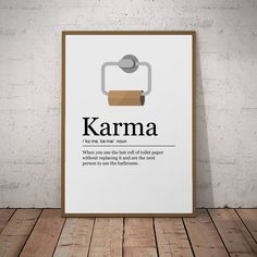 a poster with the words karma written in black and white, on a wooden floor