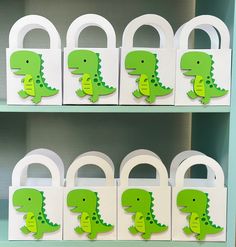 some green and white paper cut outs with alligators on them in front of a book shelf