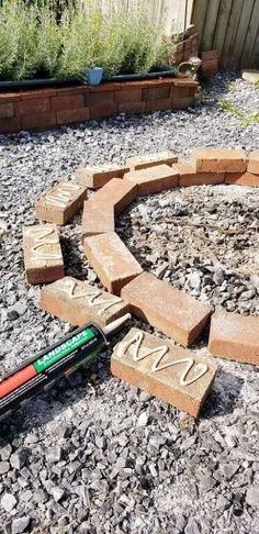 a brick circle with the word love written in it and a marker laying next to it