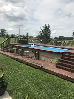 an above ground pool with steps leading up to it and a deck in the foreground