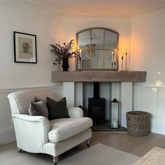 a living room filled with furniture and a fire place next to a wall mounted fireplace