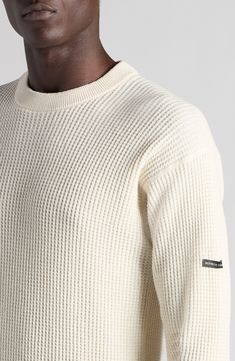 An embroidered label marks one sleeve of this hemp-and-cotton waffle-knit sweater that moves the crewneck's reinforced 'V' to the back for signature branding. 26" length (size large) Crewneck Long sleeves Ribbed cuffs and hem 55% hemp, 45% cotton Dry clean Made in Italy Designer Clothing White Crew Neck Sweater With Ribbed Collar, Off White Textured Knit Long Sleeve Sweater, Off White Long Sleeve Textured Knit Sweater, Cream Ribbed Crew Neck Sweater, Casual White Merino Wool Tops, Cream Cotton Sweater With Ribbed Cuffs, Cream Crew Sweater With Ribbed Cuffs, Cream Wool Ribbed Sweater, Cream Ribbed Wool Sweater