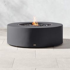 a fire pit sitting on top of a tiled floor