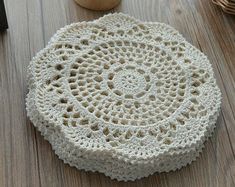 a white doily sitting on top of a wooden table