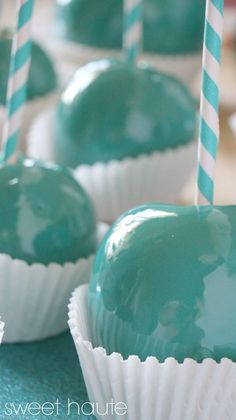 chocolate covered desserts with green icing and striped paper straws