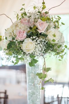 a vase filled with white and pink flowers