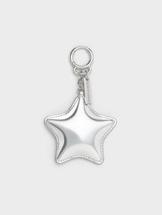 a silver star shaped key chain on a white background