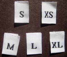 four pieces of cloth with the letters s, l, and j on them are shown