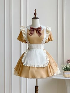 This price includes a dress and a brown bowknot.  Get ready to channel your inner maid with this stunning Khaki Lolita Fashion Apron Dress. Complete with a charming bowknot on the neckline, this dress is perfect for anyone looking to add a touch of elegance and whimsy to their wardrobe. Whether you're attending a tea party or simply want to showcase your love for Lolita fashion, this apron dress is sure to turn heads and make you feel like a true fashionista.   	 		 			Size 			S 			M 			L Yellow Maid Dress, Baking Outfit Cute, Cute Baking Outfit, Cute Doll Dress, Baking Outfit Aesthetic, Bakery Outfit, Cute Maid Dress, Kawaii Apron, Apron Outfit