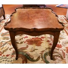 a wooden table sitting on top of a rug