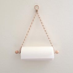 a roll of toilet paper hanging from a chain