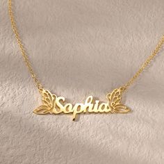 a gold necklace with the word scopia on it