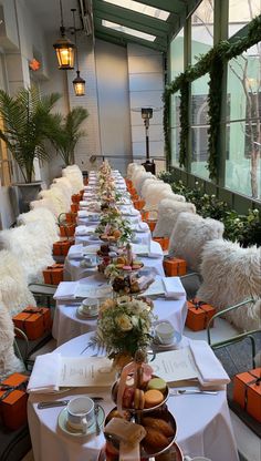 a long table is set with food and flowers