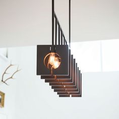 a chandelier with five lights hanging from it's sides in a room