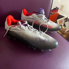 a pair of nike soccer cleats sitting on a purple chair