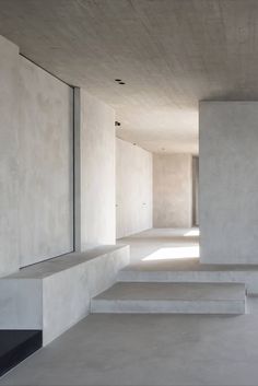 an empty room with concrete steps leading up to it