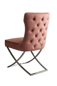 a pink chair sitting on top of a metal frame